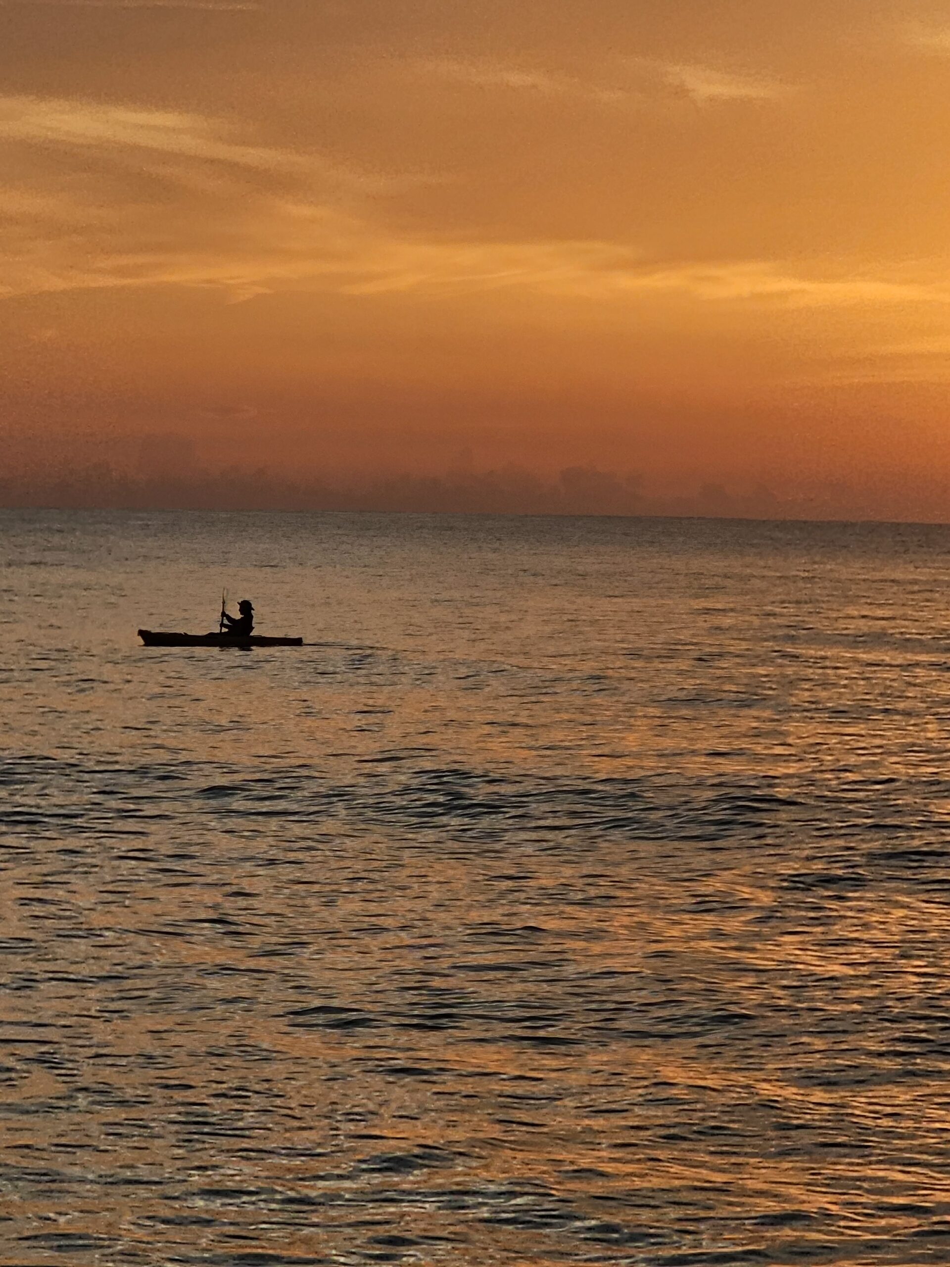 canoe in front of the sunrise