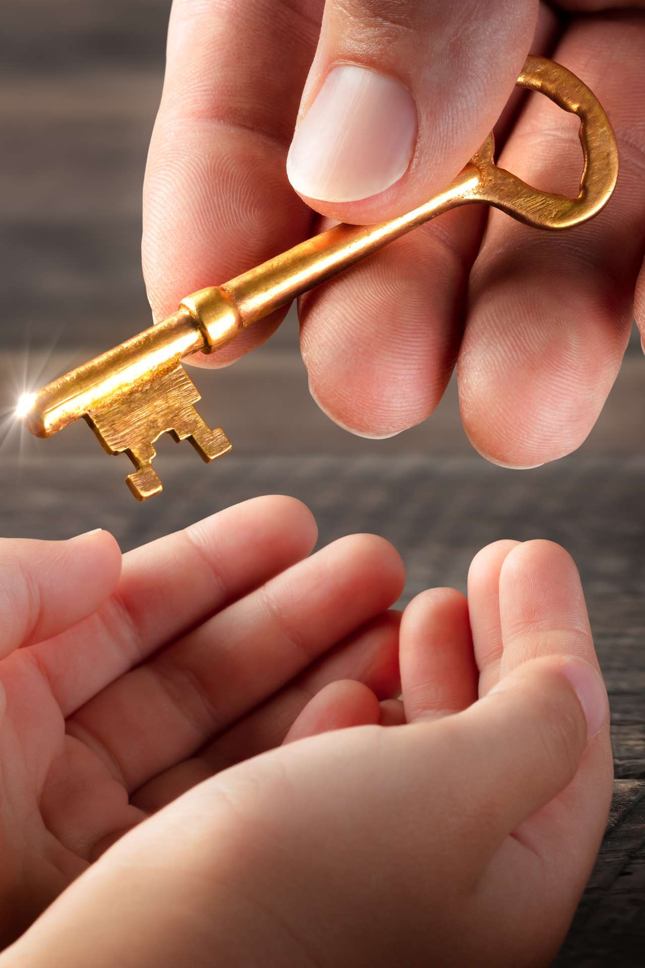 adult handing a gold key to a child